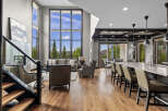 Experience luxury living in this stunning open-concept home featuring a grand living area with soaring ceilings and a wall of windows offering breathtaking views.