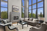 Experience luxury living in this stunning modern living room, featuring soaring floor-to-ceiling windows that flood the space with natural light and offer breathtaking views.