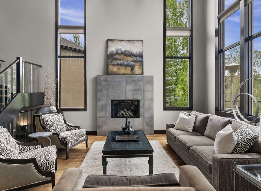 Experience luxury living in this stunning great room, featuring soaring ceilings and expansive windows that flood the space with natural light.