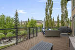 Enjoy outdoor living on this expansive deck featuring comfortable seating and a covered grill, perfect for entertaining.