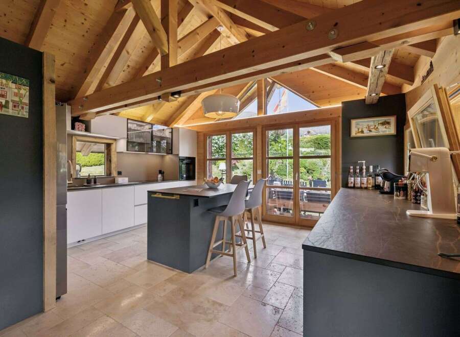 Experience modern living in this stunning kitchen featuring a spacious island with seating and sleek cabinetry.