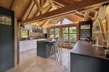 Experience modern living in this stunning kitchen featuring a spacious island with seating and sleek cabinetry.