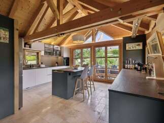 Experience modern living in this stunning kitchen featuring a spacious island with seating and sleek cabinetry.