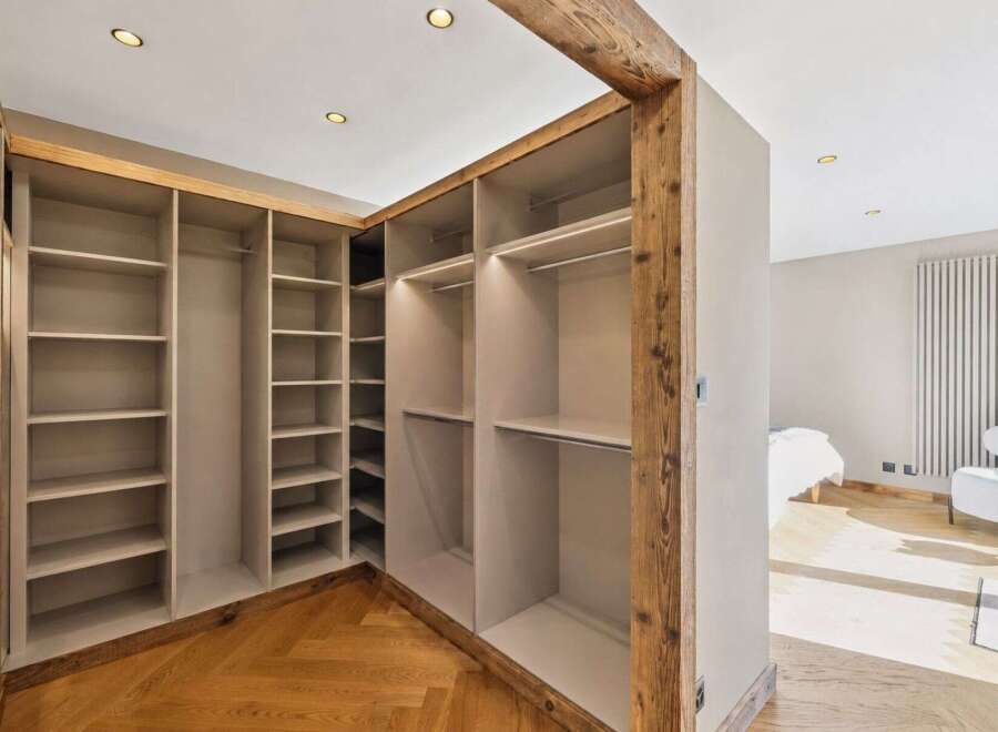 Discover this spacious walk-in closet featuring ample shelving and hanging space, perfect for organizing your wardrobe.