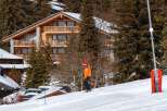 Experience the ultimate alpine lifestyle in this stunning wooden chalet, nestled amidst snow-covered pine trees.