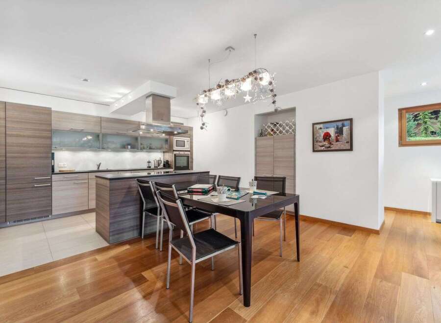 Experience modern living in this open-concept kitchen and dining area, featuring sleek cabinetry and a spacious island perfect for entertaining.