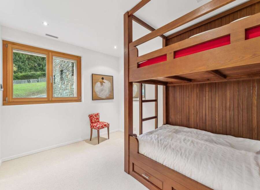 This charming bedroom features a sturdy wooden bunk bed, perfect for accommodating guests or family.