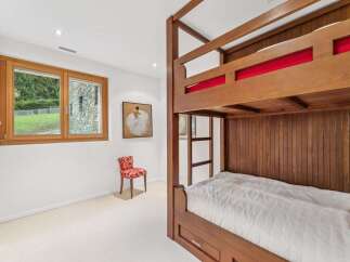 This charming bedroom features a sturdy wooden bunk bed, perfect for accommodating guests or family.