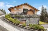 Discover this stunning wooden chalet, 'La Perle,' nestled in a picturesque mountain setting.