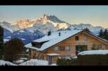 Experience the ultimate alpine retreat in this stunning wooden chalet, perfectly situated against a backdrop of majestic snow-capped mountains.