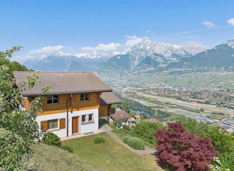 Experience breathtaking panoramic views from this stunning property, nestled amidst lush greenery with majestic snow-capped mountains as a backdrop.