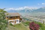 Experience breathtaking panoramic views from this stunning property, nestled amidst lush greenery with majestic snow-capped mountains as a backdrop.