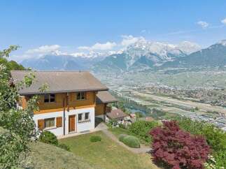 Experience breathtaking panoramic views from this stunning property, nestled amidst lush greenery with majestic snow-capped mountains as a backdrop.