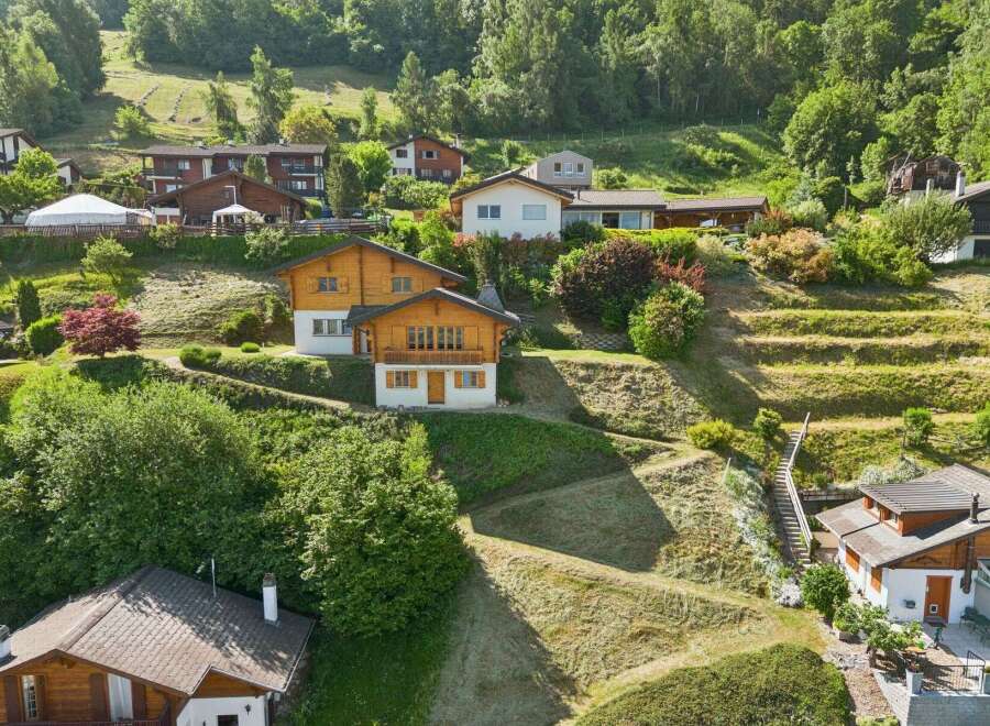 Nestled on a lush, terraced hillside, this charming property offers a serene mountain retreat.