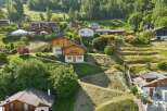 Nestled on a lush, terraced hillside, this charming property offers a serene mountain retreat.