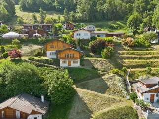 Nestled on a lush, terraced hillside, this charming property offers a serene mountain retreat.