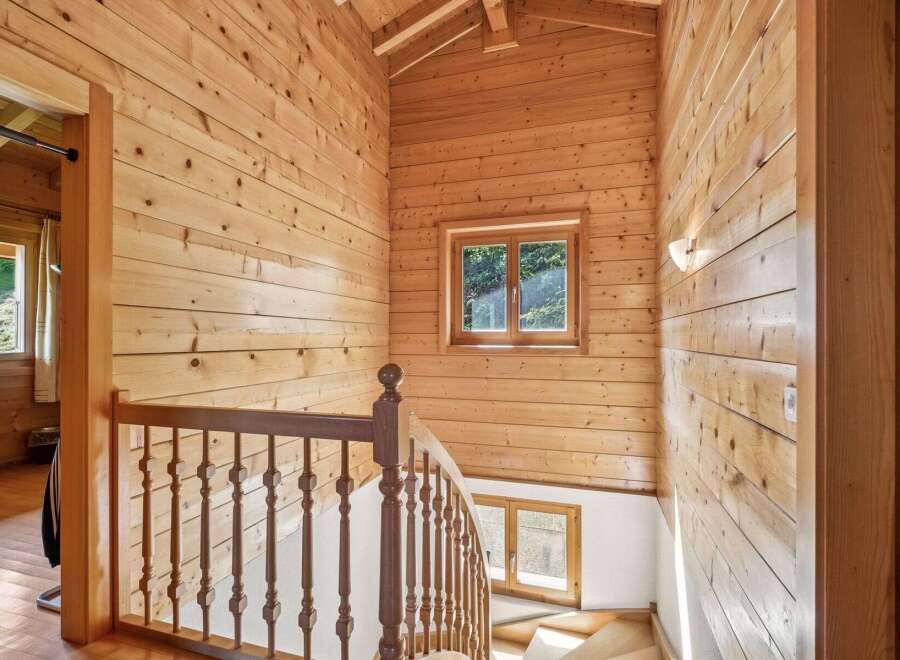 Ascend to the upper levels of this charming wooden home via a beautifully crafted staircase.