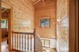Ascend to the upper levels of this charming wooden home via a beautifully crafted staircase.