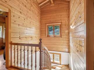 Ascend to the upper levels of this charming wooden home via a beautifully crafted staircase.