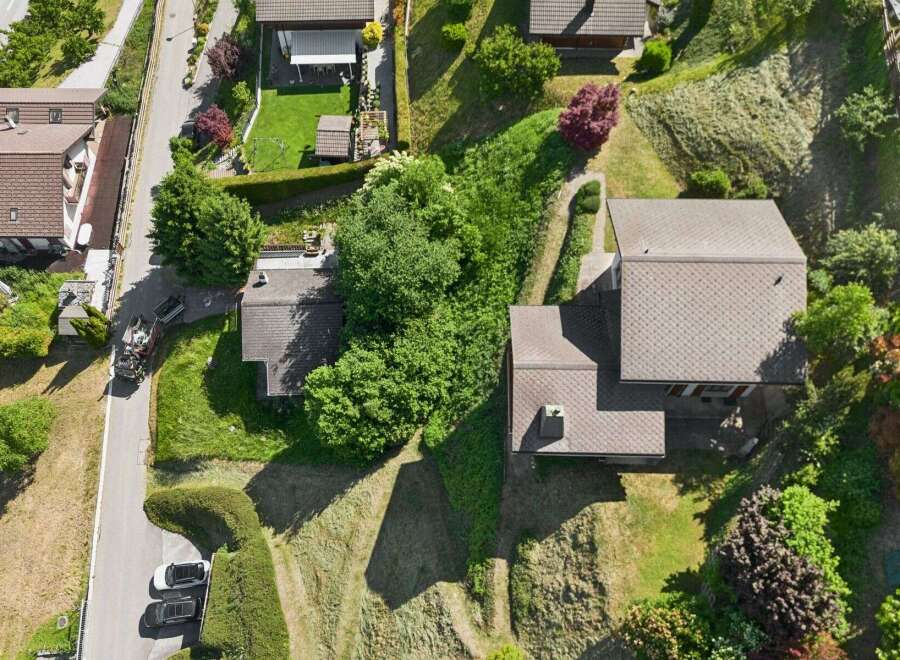 Discover this charming property featuring a well-maintained lawn and lush greenery, perfect for outdoor enjoyment.