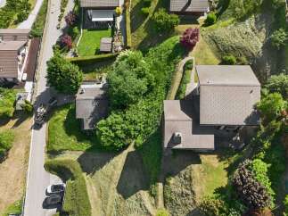 Discover this charming property featuring a well-maintained lawn and lush greenery, perfect for outdoor enjoyment.