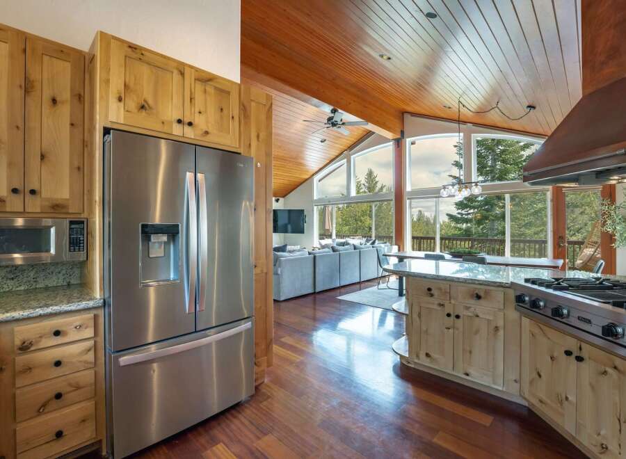 Experience breathtaking mountain views from this stunning open-concept living space, featuring a gourmet kitchen with a professional-grade Viking range and ample custom cabinetry.
