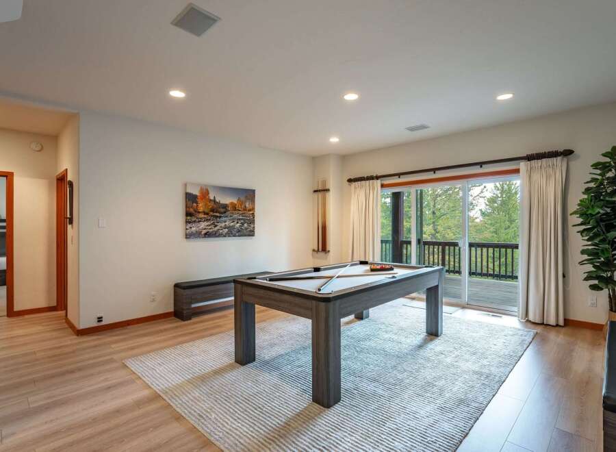Experience ultimate relaxation and entertainment in this spacious game room, featuring a professional pool table and ample seating.