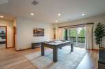 Experience ultimate relaxation and entertainment in this spacious game room, featuring a professional pool table and ample seating.