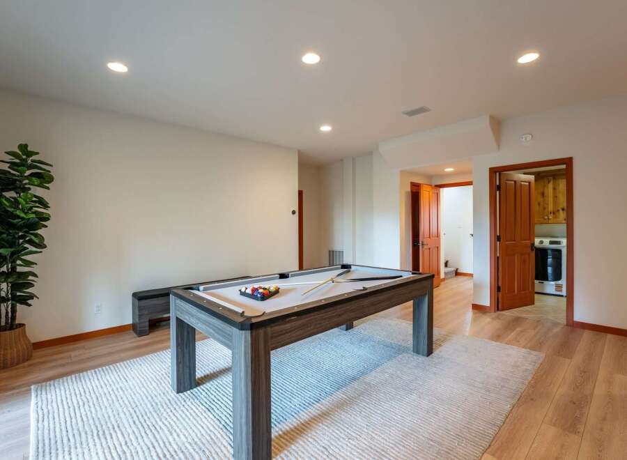 Enjoy endless entertainment in this spacious game room, featuring a stylish pool table perfect for friendly competitions.
