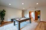 Enjoy endless entertainment in this spacious game room, featuring a stylish pool table perfect for friendly competitions.