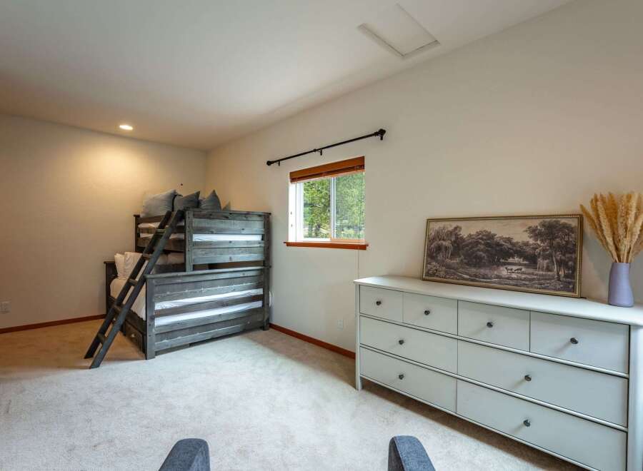 This charming bedroom features a rustic wooden bunk bed, perfect for accommodating guests or family.