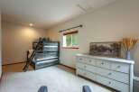 This charming bedroom features a rustic wooden bunk bed, perfect for accommodating guests or family.