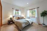 This inviting bedroom features a comfortable queen-size bed adorned with plush pillows and a cozy duvet, perfect for restful nights.