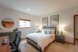Discover comfort and style in this inviting bedroom, featuring a cozy bed with crisp white linens and decorative pillows.