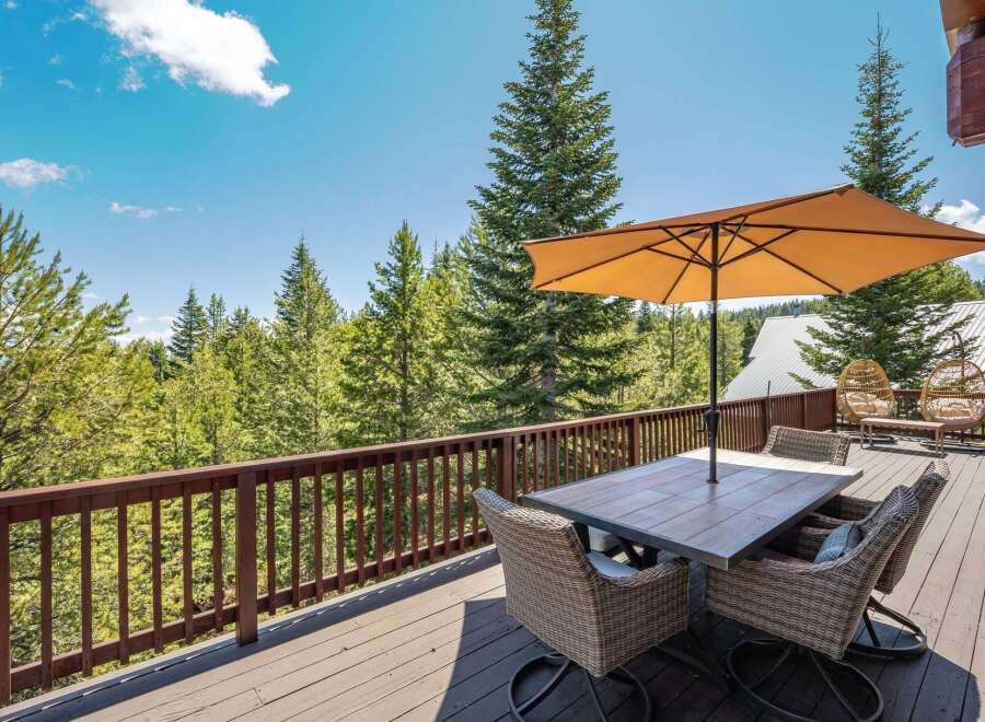 Enjoy breathtaking mountain views from this expansive wooden deck, perfect for outdoor dining and relaxation.