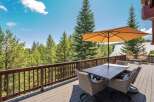 Enjoy breathtaking mountain views from this expansive wooden deck, perfect for outdoor dining and relaxation.