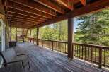Enjoy the serene mountain views from this expansive wooden deck, perfect for outdoor living and entertaining.