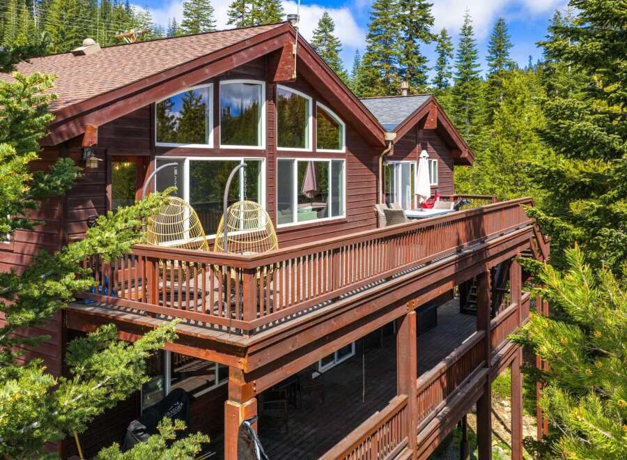 Experience mountain living in this stunning wooden home nestled among tall pine trees.