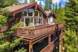 Experience mountain living in this stunning wooden home nestled among tall pine trees.
