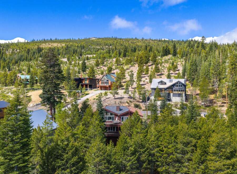 Nestled amidst a lush pine forest, this stunning mountain property offers a serene escape with multiple modern homes.
