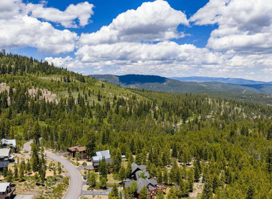 Nestled amidst a lush pine forest, this property offers a serene mountain retreat with stunning panoramic views.