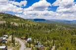 Nestled amidst a lush pine forest, this property offers a serene mountain retreat with stunning panoramic views.