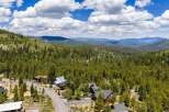 Nestled amidst a lush pine forest, this property offers a serene mountain retreat with stunning panoramic views.