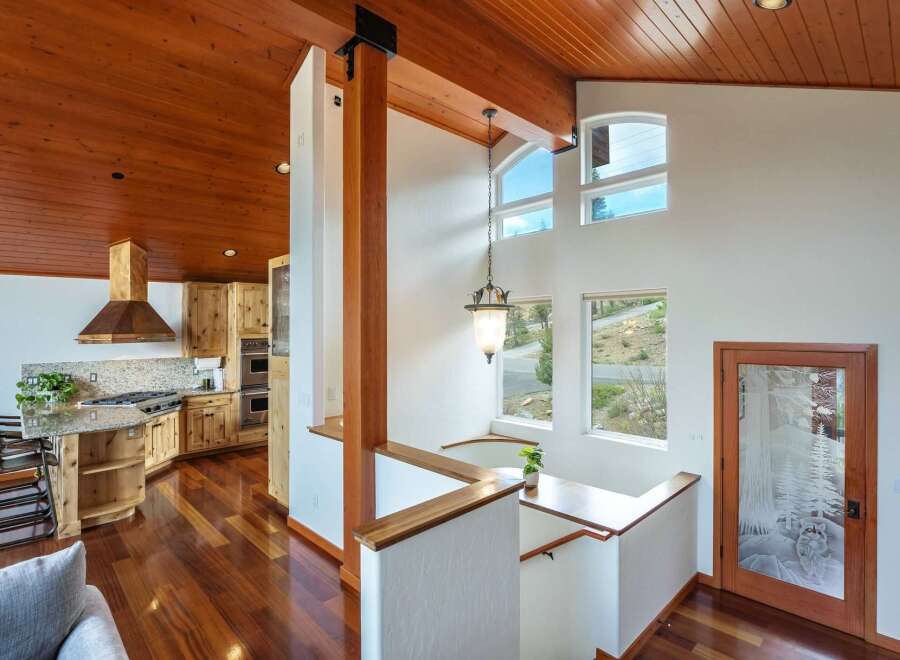 Experience rustic charm in this stunning home featuring a gourmet kitchen with custom wood cabinetry and a granite-topped island, perfect for entertaining.