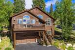 Nestled amidst lush greenery, this charming wooden home offers a serene mountain retreat.