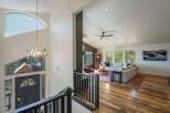 Experience breathtaking mountain views from this stunning home, featuring a grand entryway with a unique antler chandelier and a large, arched window.