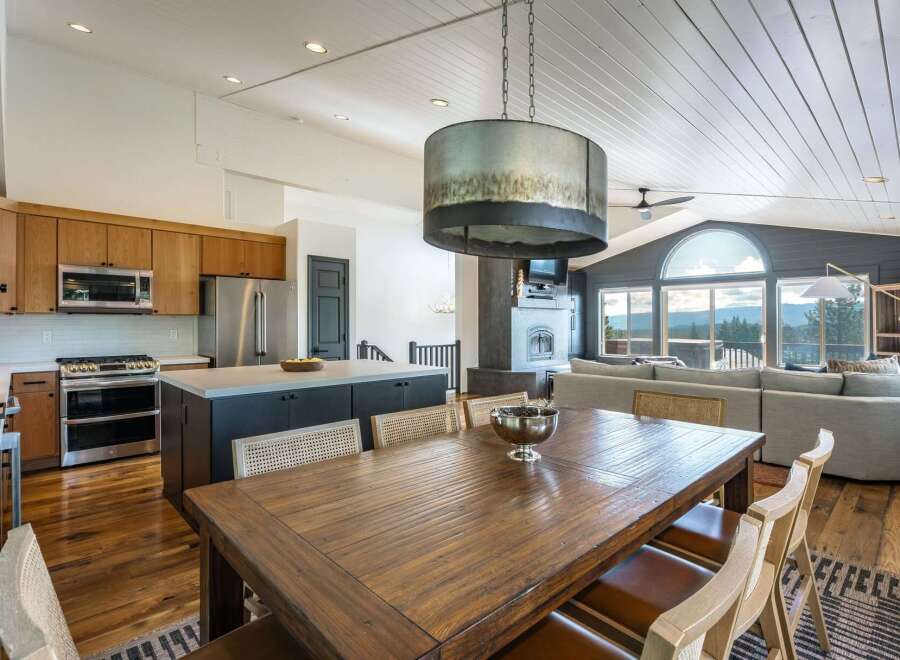Experience breathtaking mountain views from this stunning open-concept living space, featuring a gourmet kitchen with custom cabinetry and a large island perfect for entertaining.