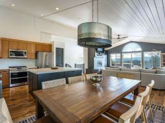 Experience breathtaking mountain views from this stunning open-concept living space, featuring a gourmet kitchen with custom cabinetry and a large island perfect for entertaining.