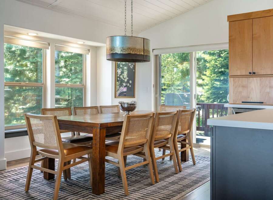 This dining area features a large wooden table with cane-backed chairs, perfect for family gatherings.