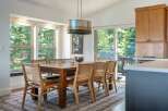 This dining area features a large wooden table with cane-backed chairs, perfect for family gatherings.